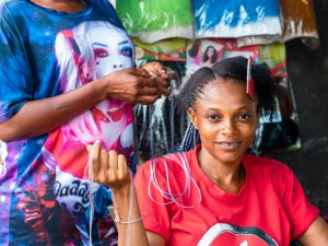 Team of braiders working together at a braiding salon in San Diego