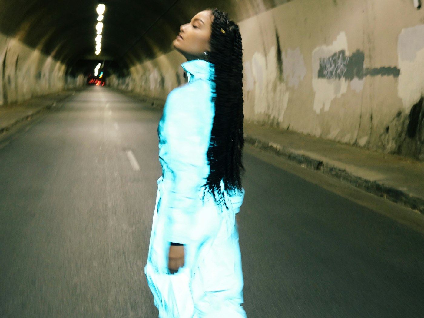 Client walking outdoors wearing long braids in San Diego