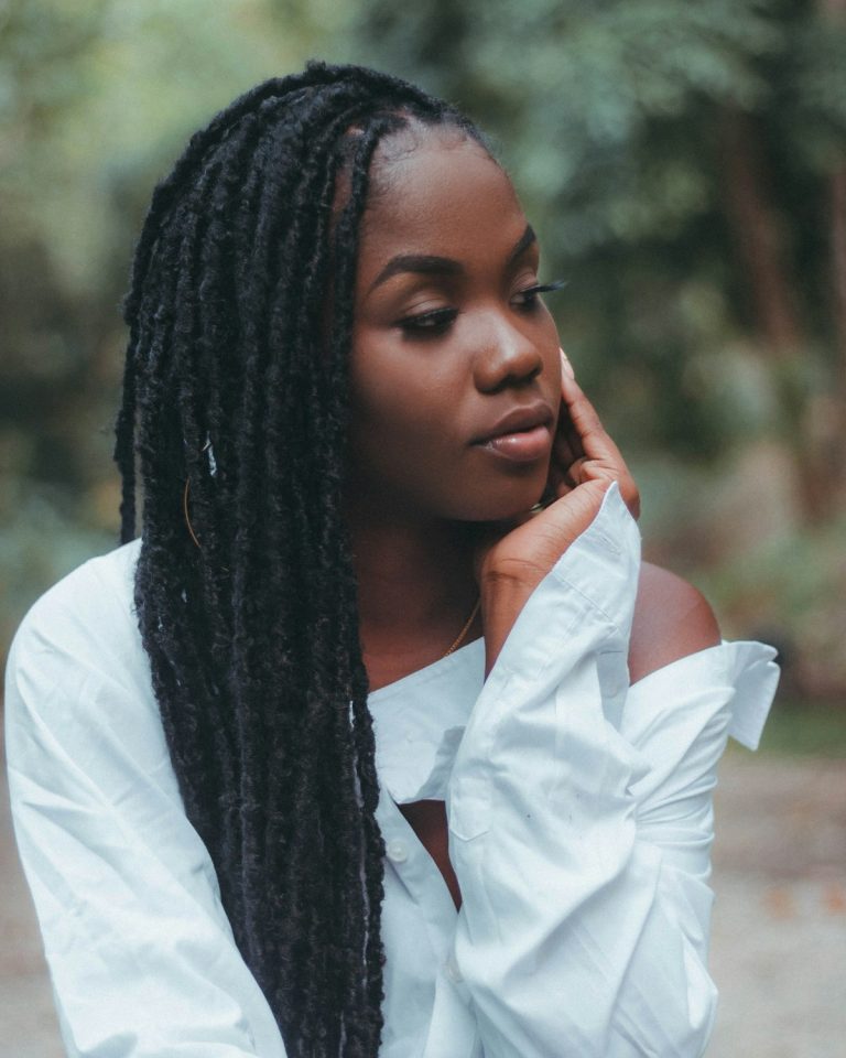 Client with long box braids and glasses, affordable hair braiding San Diego