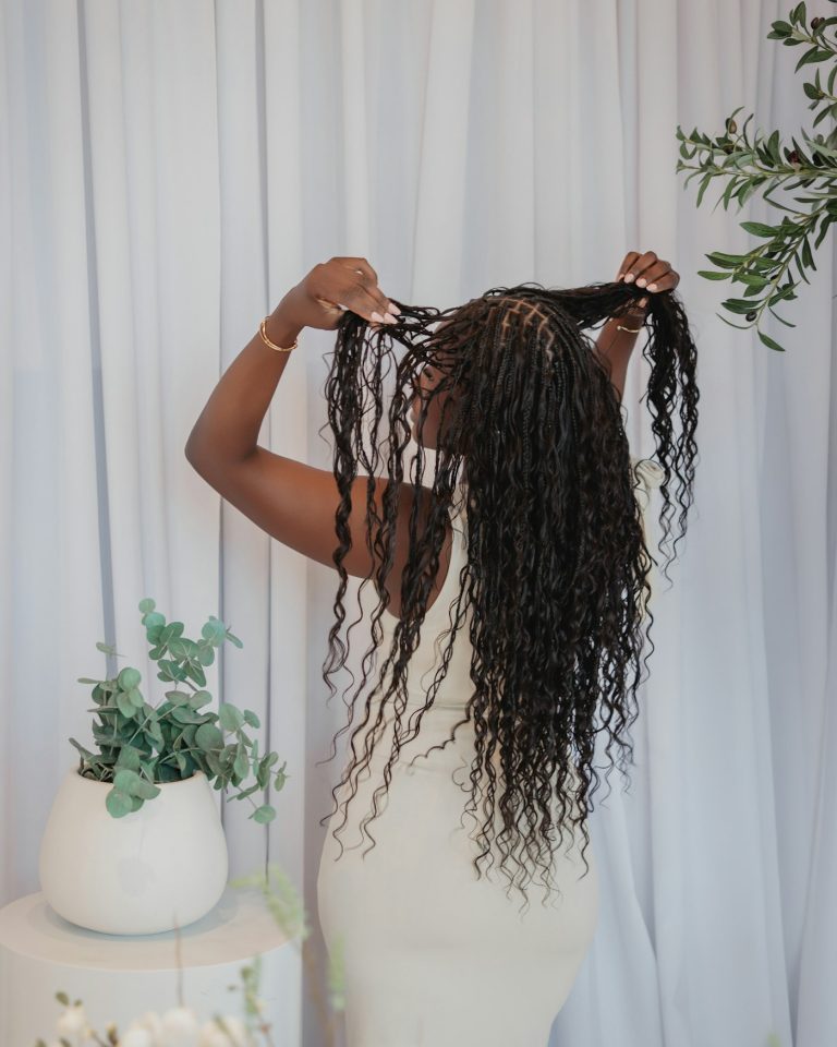 Client holding long braided hair extensions, hair extensions San Diego